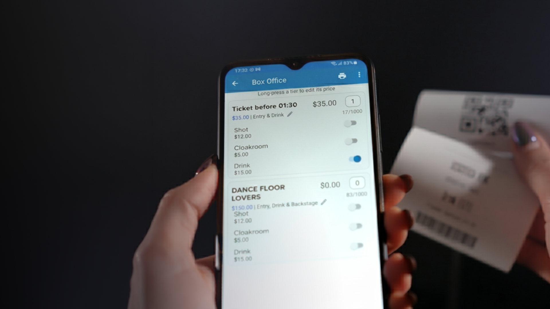 Alt="Mobile ticket sales screen with a printed ticket in the background."